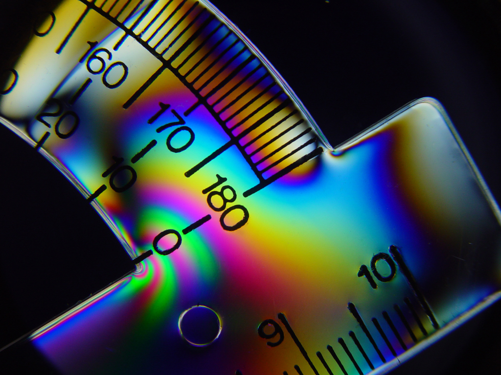 Stress concentration at a sharp corner in a plastic protractor (Photoelastic visualization).