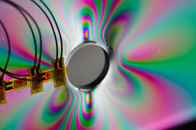 Stress concentration around a hole visualized using photoelastic methods & strain gauges.