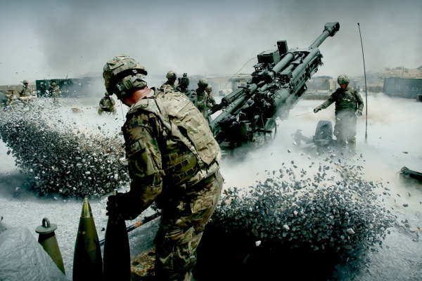 US Soldiers with an ISAF (International Security Assistance Force) component man a M777 towed 155mm Howitzer artillery piece.